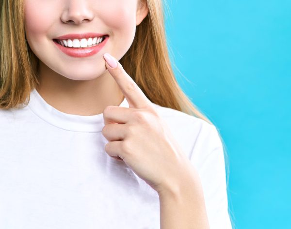 Perfect healthy teeth smile of a young woman. Teeth whitening. Dental clinic patient. Image symbolizes oral care dentistry, stomatology